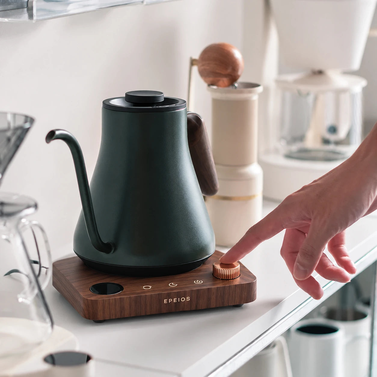 A hand operating the U.S. kettle on a home coffee counter