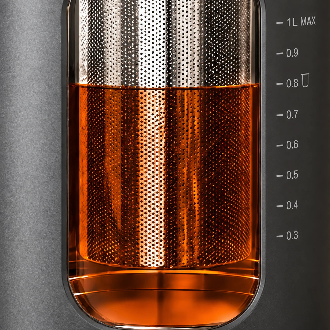 Close view of the perforated infuser through the tea kettle window